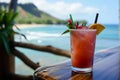 Refreshing red cocktail of tropical fruits with a slice of lemon or orange and green herbs to decorate on a wooden table Royalty Free Stock Photo