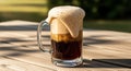 Refreshing Root Beer Float with Overflowing Foam on a Wooden Table Outdoors Royalty Free Stock Photo
