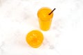 Refreshing Slush drink in plastic cup and tall glass orange slushie drink on the table, top view. Summer ice drink. Sweet citrus Royalty Free Stock Photo