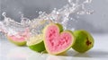 Refreshing splash of water on heart-shaped pink guavas Royalty Free Stock Photo