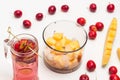 Refreshing summer apple drink with ice in glass. Sliced apples on stick. Melon sliced in blender jar. Small red apples and slice