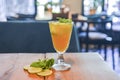 Refreshing summer beverage - cold alcohol drink with lemon and lime. Citrus cocktail in a glass on a rustic wooden table Royalty Free Stock Photo