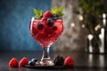 Refreshing summer cocktail with berries in a glass on a dark background