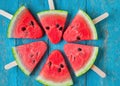 Refreshing Summer Delights: Watermelon Slice Popsicles on Blue Rustic Wood Background, a Tropical Treat Royalty Free Stock Photo