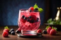 Refreshing summer drink with berries in a glass on a wooden table