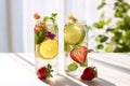 Refreshing summer drink infused detox water with edible flowers, strawberry and mint Royalty Free Stock Photo