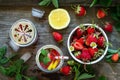 Refreshing Summer drink. Lemonade with fresh strawberries, ice and lemons on a rustic wooden table. Top view flat lay. Royalty Free Stock Photo