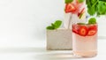 A refreshing summer drink with strawberries, lemon and mint in a glass on a light background. Strawberry lemonade Royalty Free Stock Photo