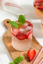 A refreshing summer drink with strawberries, lime and mint in a glass. Ice-cold summer lemonade. Royalty Free Stock Photo