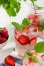 A refreshing summer drink with strawberries, lime and mint in a glass. Ice-cold summer lemonade. Royalty Free Stock Photo
