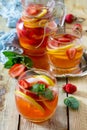 Refreshing summer drink strawberry mojito on a wooden table. The concept of eating vegetarians, fresh vitamins