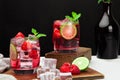 Refreshing summer drink with strawberry slices, lime, and mint leaf  in glasses on dark background beverage soda Royalty Free Stock Photo