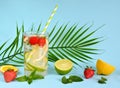 Refreshing summer drinks of lemon, lime, strawberry, orange, mint on a pink background. Detox, healthy eating, fitness drinks. Royalty Free Stock Photo