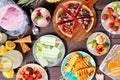 Refreshing summer food table scene, top view over dark wood