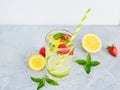 Refreshing summer lemonade in a glass cup from lemon, lime, strawberry, orange, mint on a white background. Flax drinks Royalty Free Stock Photo