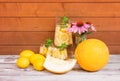 Refreshing summer melon lemonade, lemons, melon and echinacea flowers on aged wooden table Royalty Free Stock Photo