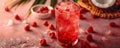 Refreshing Summer Pomegranate Cocktail with Ice in Tall Glass, Surrounded by Fresh Ingredients on Pink Surface Royalty Free Stock Photo