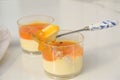 Refreshing summer time dessert of mango panna cotta with spoon