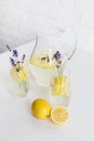 Refreshing summertime lemonade with lavender flowers in glasses and jar