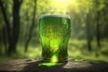 Refreshing three glass of green beer outdoor in the wood