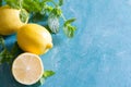 Refreshing water with lemon, mint and ice for summer heat background