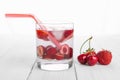 Refreshing water from red berries in a glass on wooden table. Homemade tasty and healthy drinks Royalty Free Stock Photo