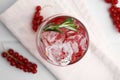Refreshing water with red currants and rosemary in glass on white table, top view Royalty Free Stock Photo