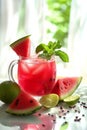 Refreshing watermelon drink with lime and mint on a sunny background Royalty Free Stock Photo