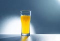 refreshing yellow carbonated drink in a tall glass. Cold glass, drops of condensation, orange juice, lemon juice,