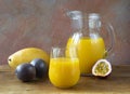 A refreshing yellow drink. The cocktail consists of mango juice, passion fruit, and citrus fruits: orange and lemon in a glass jug Royalty Free Stock Photo