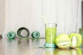 Closeup of measuring type, green smoothie and fruits on wooden floor.Concept of healthy, active nad sporty life.