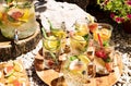 Refreshments with lemon, lime, orange, grapefruit and mint in glasses and a large jug with a crane stand on a wooden tray Royalty Free Stock Photo