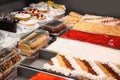 Refrigerated display case with delicious desserts in supermarket