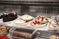 Refrigerated display case with delicious desserts in supermarket