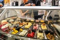 Refrigerated display case with a large assortment of soft ice cream in an Italian store