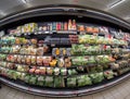 refrigerated shelf with packs of precooked soups and clean salads