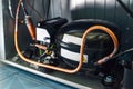 Refrigerator compressor with copper pipes inside appliance Royalty Free Stock Photo