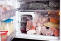 Refrigerator with frozen food meat, milk, fruits and vegetables Royalty Free Stock Photo