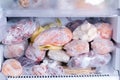 Refrigerator with frozen food. Open fridge freezer meat, milk, vegetables. Royalty Free Stock Photo