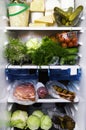 Refrigerator full of assorted food ingredients, vegetables, meat and dairy products close up health care, dieting concept Royalty Free Stock Photo