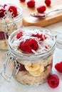 Refrigerator oatmeal with fresh raspberries and coconut in jars Royalty Free Stock Photo