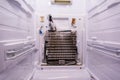 Refrigerator repair. Freezer compartment back panel removed. Evaporator coils with a frozen thermostat Royalty Free Stock Photo