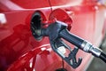 refuel the red car at the gas station with gasoline. Crisis of oil products. Energy ecology Royalty Free Stock Photo