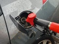 refueling Car fill with petrol gasoline at gas station and petrol pump filling fuel nozzle in fuel tank