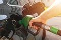 Refueling the car at a gas station fuel pump. Man driver hand refilling and pumping gasoline oil the car with fuel at he refuel st Royalty Free Stock Photo