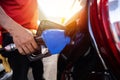 Refueling the car at a gas station fuel pump. Man driver hand refilling and pumping gasoline oil the car with fuel at he refuel st Royalty Free Stock Photo