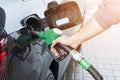 Refuelling the car at a gas station fuel pump. Man driver hand refilling and pumping gasoline oil the car with fuel at he refuel s Royalty Free Stock Photo