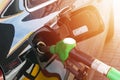 Refueling the car at a gas station fuel pump. Man driver hand refilling and pumping gasoline oil the car with fuel at he refuel st Royalty Free Stock Photo