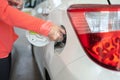 Refueling, filling tank of a car. woman`s hand closing the deposit door of the car after filling in the tank with petrol Royalty Free Stock Photo