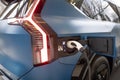 refueling gun Charger, Kia taillights close-up, electric Kia EV9 GT-Line, electric vehicle charging station, South Korean ev,